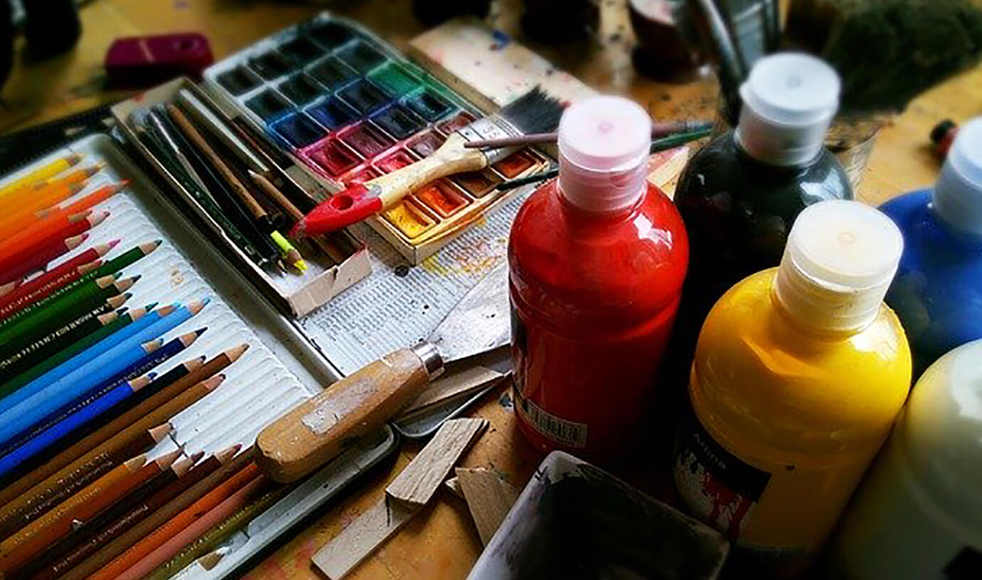 Art supplies - pencils and bottles of paint